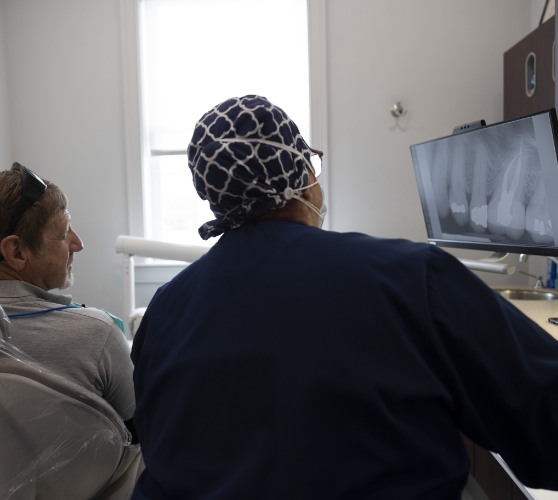 Dentist showing a patient x rays of their teeth