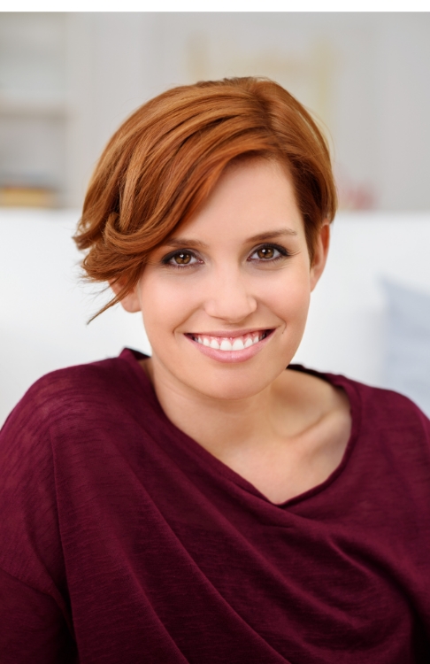 Woman in red sweater smiling after gum disease treatment in Easton