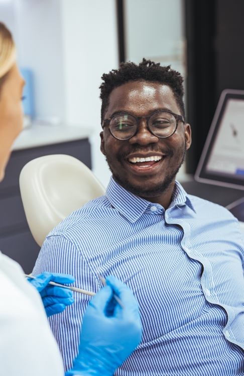 Man smiling at his dentist during preventive dentistry checkup