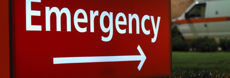 Sign outside of hospital with the word emergency and an arrow