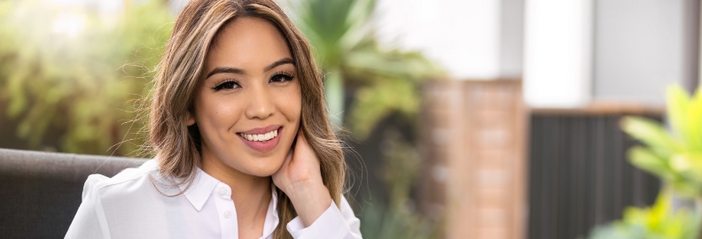 Woman in white collared shirt smiling